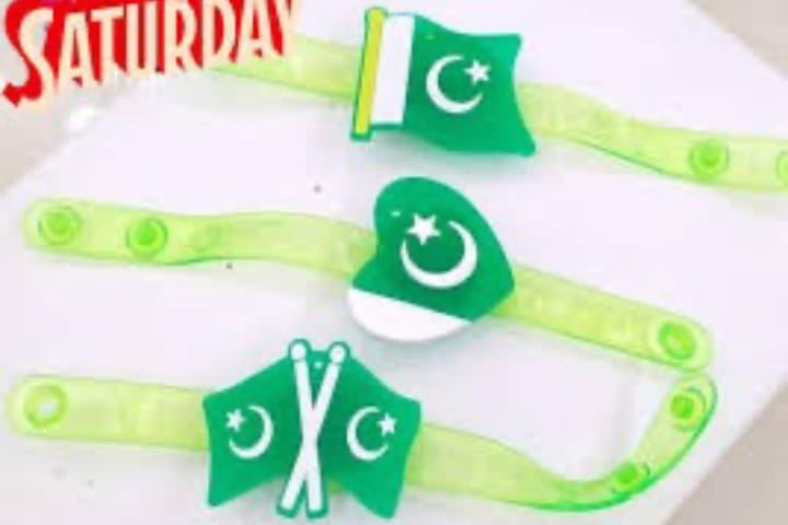 Three green plastic headbands with crescent and star designs, featuring one with the Pakistan flag and two with crossed crescent and star motifs, displayed on a white surface.